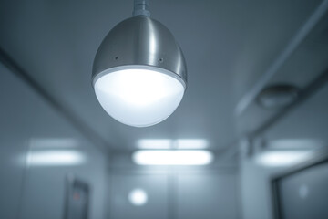 A modern pendant light hanging in a room.