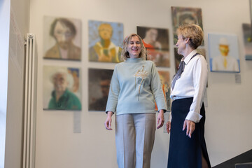 Fototapeta premium Two Women Viewing Art Exhibition In Gallery