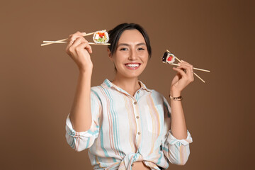 Happy young woman with different sushi on brown background © Pixel-Shot