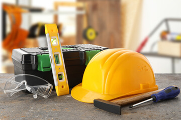 Fototapeta premium Hardhat, toolbox and construction tools on grunge table against white background