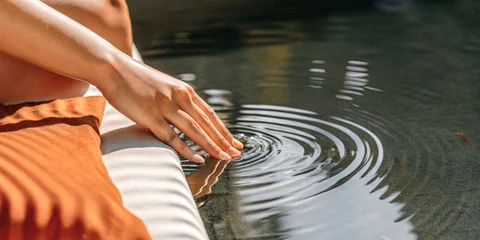 Fotobehang Rustgevend Balancing emotions concept and serenity with a gentle touch on the water surface  © guguart
