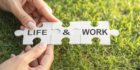 Concept of creating a balance between life and work with puzzle pieces labeled 'Life' and 'Work' on green grass