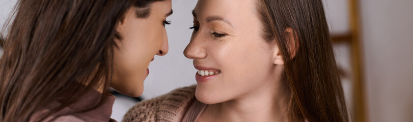 Obraz premium Cozy winter moments shared between a loving lesbian couple in soft attire