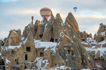 Colorful hot air balloons flying above Nevsehir Cappadocia fairy chimneys © yalcinsonat