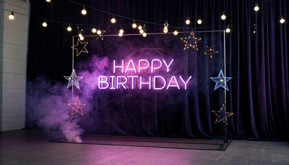 A photo of a stage with a dark purple curtain, a metal frame with hanging star decorations, and a neon sign that reads "HAPPY BIRTHDAY" in pink, with a puff of smoke.