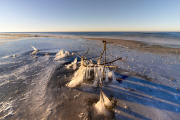 The Baltic Sea in winter. Winter landscape on the Polish coast. Sunset.