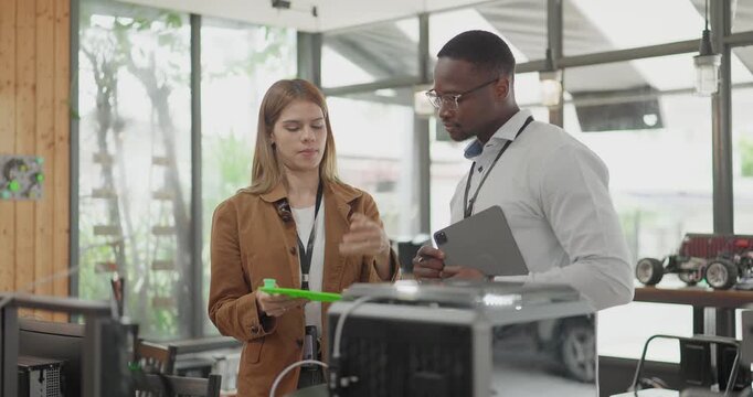 A diverse team of startup professionals collaborates on a 3D printing project in a modern workspace. Highlighting innovation, teamwork, and the prototyping process in a creative tech environment.
