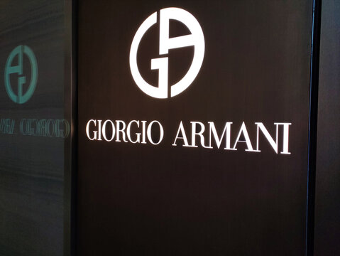 Rome, Italy - February 15, 2026: Giorgio Armani brand logo displayed prominently on a dark wall, showcasing elegant design and luxury fashion identity in a retail environment