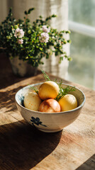 Naturally dyed Easter eggs with herbs in ceramic bowl by sunny window