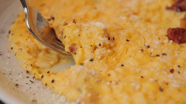 Risotto carbonara texture, delicious twist on the famous first course made with egg yolks, pecorino, and guanciale. High quality 4k footage