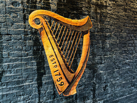 Rusted harp Guinness logo wall art in Manchester captures urban music heritage and bronze texture