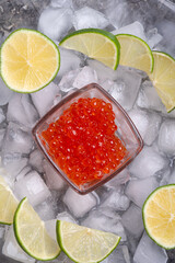  fresh red  salmon caviar with lime around ice. macro shot.  Protein luxury delicacy  healthy food. close up. flat lay