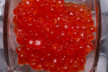  fresh red  salmon caviar with lime around ice. macro shot.  Protein luxury delicacy  healthy food. close up