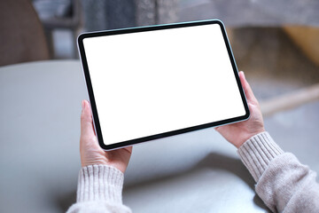 Mockup image of a woman holding digital tablet with blank white desktop screen