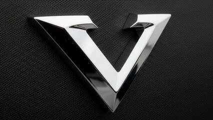 Sleek metallic triangular logo with a bold, modern geometric design on a dark background