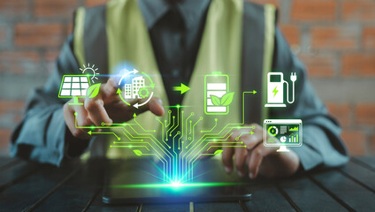 Construction worker engineer using tablet with virtual smart energy and net zero icons Solar, Battery, EV, Green building for sustainable infrastructure concept, SDG Sustainable Development Goals © HappyEva