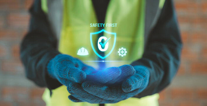 Construction worker hands holding virtual shield zero accident icon with safety first text for industrial protection concept, Occupational Health and Safety OHS, EHS Environment, Health, and Safety