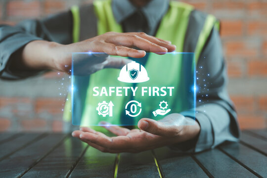 Worker hands holding virtual safety helmet icon with gear and zero accident symbol for construction site safety, Occupational Health and Safety OHS, EHS Environment, Health, and Safety