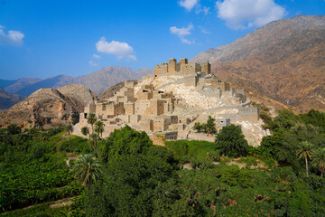 Fototapeta premium Thee Ain Heritage Village, the famous marble village of Al-Baha against a desert mountain backdrop in Saudi Arabia
