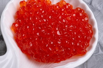  fresh red  salmon caviar with lime around ice. macro shot.  Protein luxury delicacy  healthy food