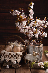 Easter background with wicker basket and branches of blossoming fruit tree