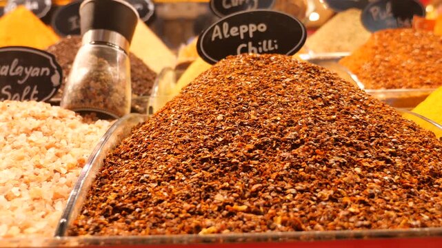 Display of diverse colorful spices at traditional oriental market stall with focus on aleppo chili