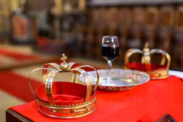  Two crowns, a cup of wine and a cross prepared for baptism. Preparation for an Orthodox wedding