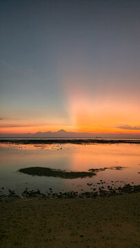 Serene seascape during sunset with shimmering tidal reflections Gili Trawangan Sunset