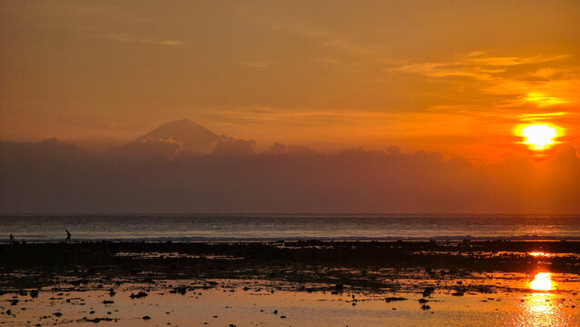 Colorful evening sky reflects on calm tidal flats demonstrating serenity Gili Trawangan Sunset