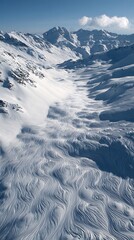 Aerial view of a vast snow-covered mountain range with peaks and valleys