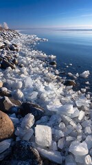 A frozen shoreline with ice formations and a distant horizon under a clear sky
