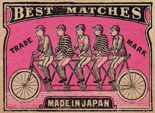 A vintage matchbox label features five boys in striped shirts and shorts riding a tandem bicycle. The label reads "BEST MATCHES" and "MADE IN JAPAN".