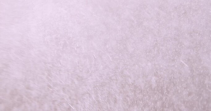Tiny snow or dust randomly flying in the air, empty space template for objects advertisement. Many dust particles cloud of white powder on empty lit background.