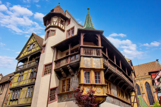 Famous Renaissance Maison Pfister with painted facade and wooden balcony dominating a historic Colmar street corner.