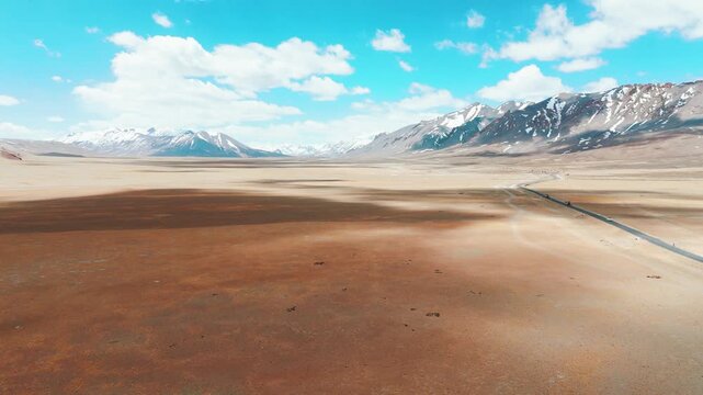 4K Aerial landscape of Ladakh. Road passing through more plain in Ladakh, India. Beautiful road leading towards Himalaya mountains. Travel, adventure and road trip concept.