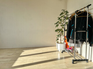 Clothes rack with jackets in minimalist empty room