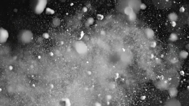 Sparkling water drops create colorful lights in dark background during a lively celebration at night