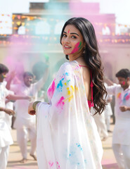 Naklejka premium Beautiful Indian women celebrating Holi rangpanchami dhulivandan with vibrant colors and joyful laughter