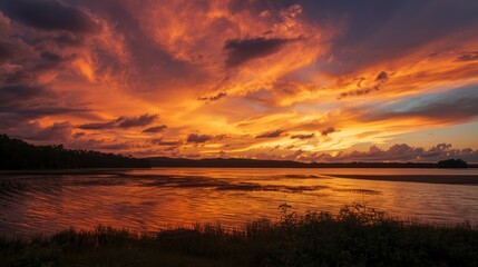 Obraz premium Serene sunset over calm waters reflecting vibrant hues of orange and pink
