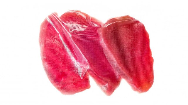 Packaging and Freezing Tuna Steaks. Tuna steaks are vacuum packed and rapidly cooled with an ice jet, creating the effect of white steam on a white background