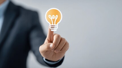 Businessman Touching Light Bulb Concept of Innovation and Ideas in Modern Workspace