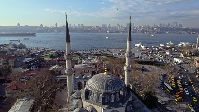 Aerial footage of Yeni Valide Mosque and &Uuml;sk&uuml;dar Ferry Pier in Istanbul. Ferries crossing the Bosphorus, waterfront activity and Ottoman architecture highlight the city&rsquo;s daily life.