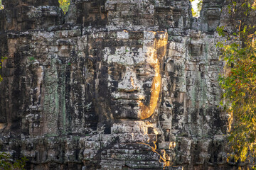 Fototapeta premium Giant stone Buddha face at Angkor Thom ancient city South gate, Angkor, Siem Reap, Cambodia