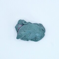 Obraz premium Used gray kneadable eraser isolated on square white background from top angle view.