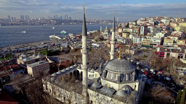 Aerial footage of Yeni Valide Mosque and &Uuml;sk&uuml;dar Ferry Pier in Istanbul. Ferries crossing the Bosphorus, waterfront activity and Ottoman architecture highlight the city&rsquo;s daily life.