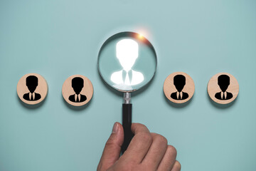 Target audience and recruitment concept with magnifying glass highlight select business profile among candidates. Talent acquisition, customer segmentation, HR selection and market targeting strategy.