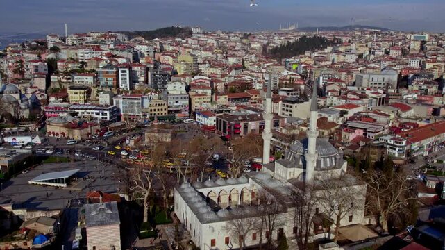 Aerial view of Yeni Valide Mosque area in &Uuml;sk&uuml;dar with pier connection and busy city traffic. Ottoman architecture, main roads and coastal transportation reflect Istanbul&rsquo;s daily urban life.