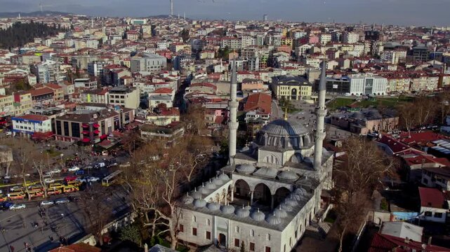 Aerial view of Yeni Valide Mosque area in &Uuml;sk&uuml;dar with pier connection and busy city traffic. Ottoman architecture, main roads and coastal transportation reflect Istanbul&rsquo;s daily urban life.