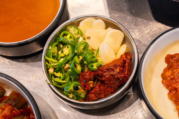 slices of chili pepper and garlic and traditional Korean sauce called galchi sokgeot
