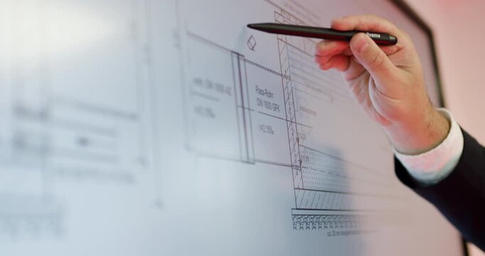 Architect pointing at technical blueprint on digital whiteboard